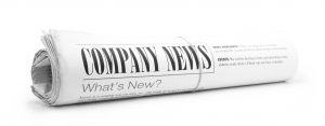 Rolled up newspaper with Company News on it. All text created by photographer. Concept for NEWS section of website.